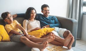 family on sofa, watching TV