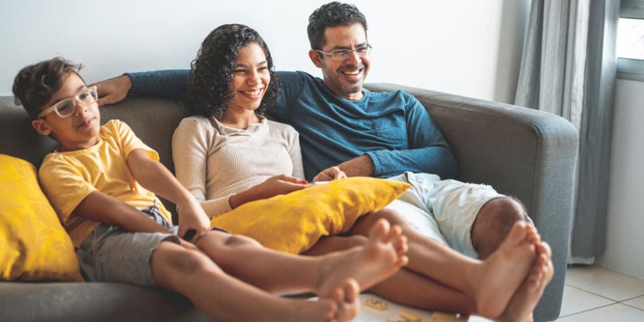 family on sofa, watching TV