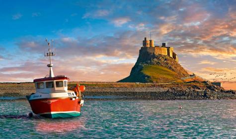 Lindisfarne Castle & fishing boat at sunset